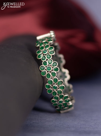 Oxidised screw type bangle floral design with emerald stones