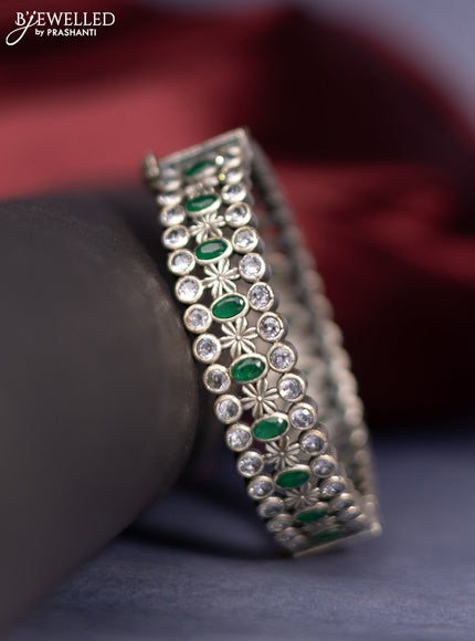 Oxidised screw type bangle with emerald and cz stones