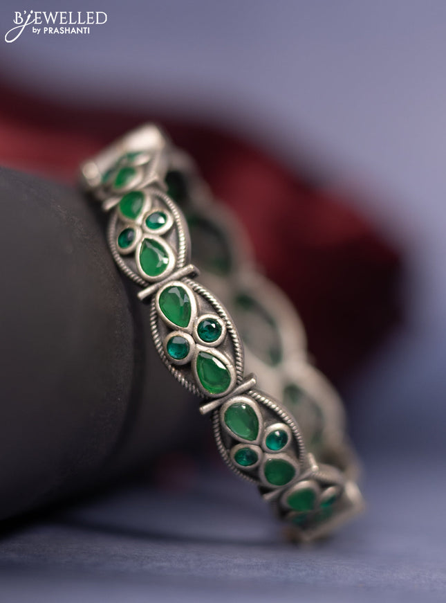 Oxidised screw type bangle with emerald stones