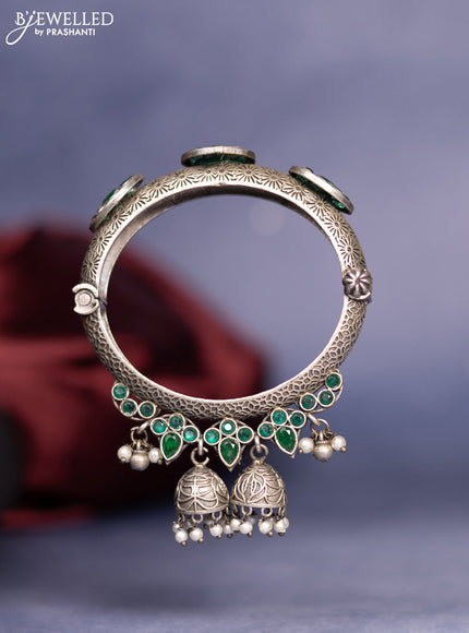 Oxidised screw type bangle with emerald stones and pearl hangings