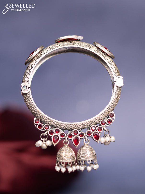 Oxidised screw type bangle with ruby stones and pearl hangings
