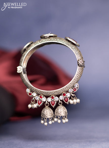Oxidised screw type bangle with ruby & white stones and pearl hangings