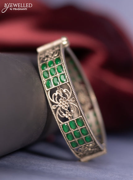 Oxidised screw type bangle with emerald stones
