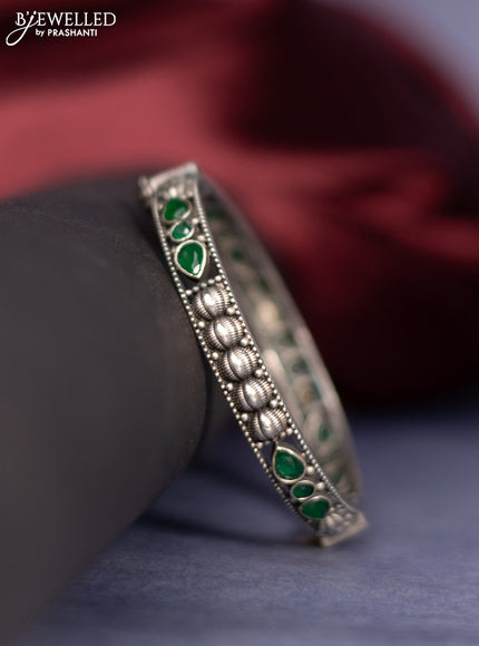 Oxidised screw type bangle with emerald stones