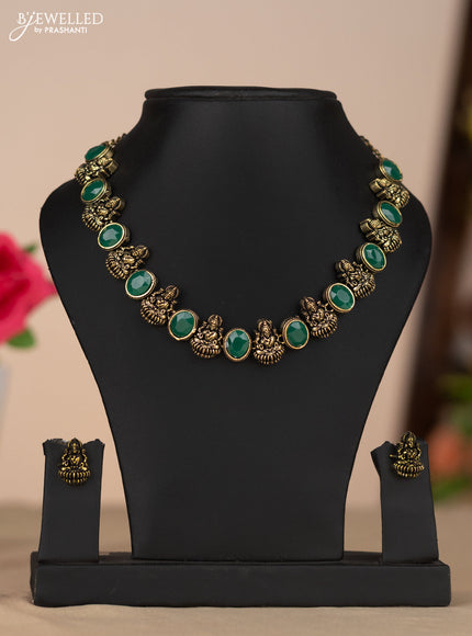 Oxidised necklace with lakshmi design and green stone in gold finish