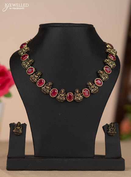 Oxidised necklace with lakshmi design and red stone in gold finish