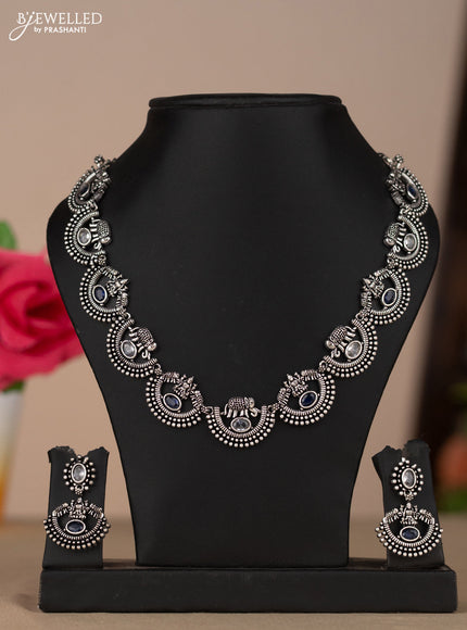 Oxidised necklace with elephant and lakshmi deisgn in blue & white stones
