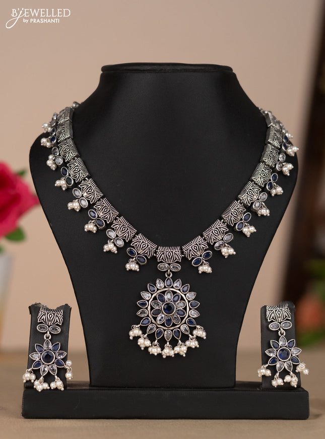 Oxidised necklace with floral design in blue & white stones