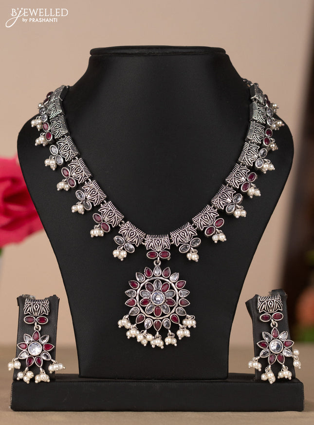Oxidised necklace with floral design in red & white stones
