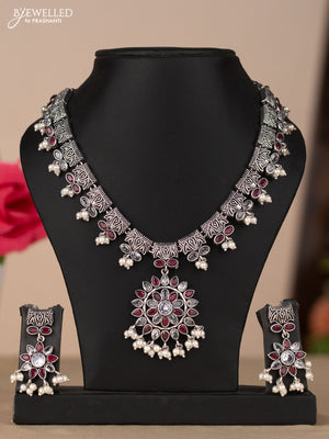 Oxidised necklace with floral design in red & white stones