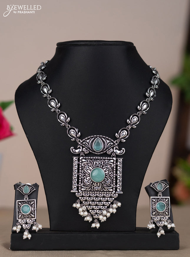 Oxidised necklace with floral design in pastel blue stones