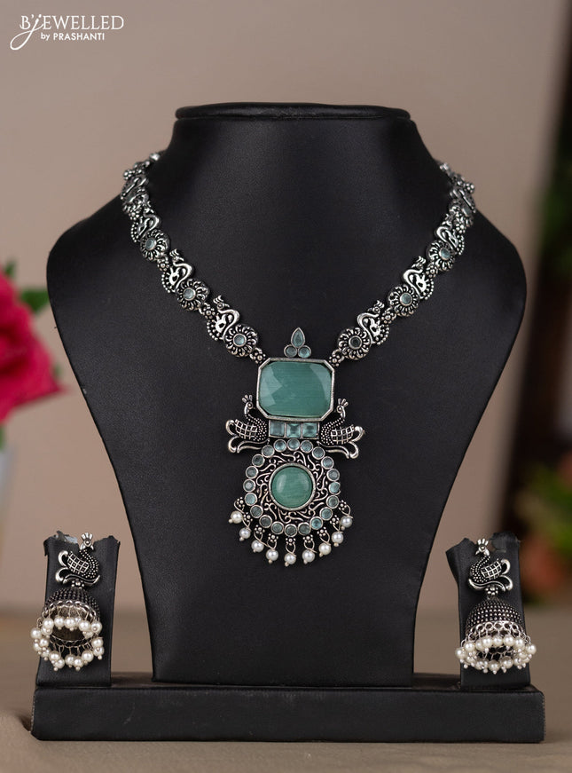 Oxidised necklace with peacock design in pastel blue stones