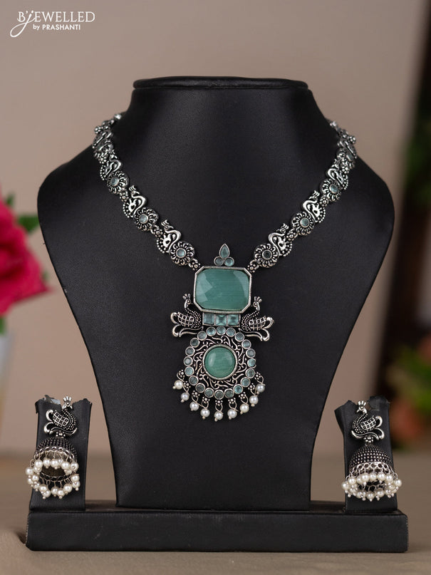 Oxidised necklace with peacock design in pastel blue stones