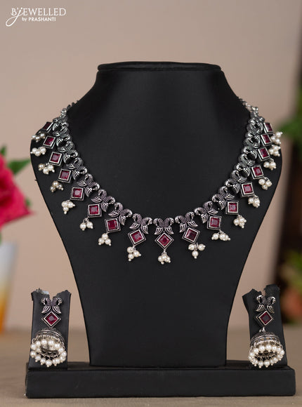 Oxidised necklace with double peacock design in red stones