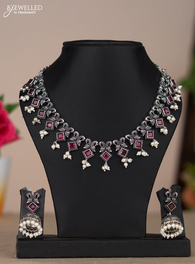 Oxidised necklace with double peacock design in red stones