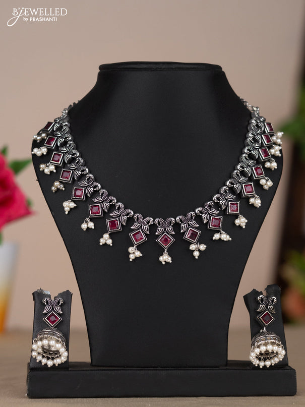 Oxidised necklace with double peacock design in red stones