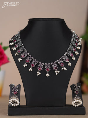 Oxidised necklace with double peacock design in red stones