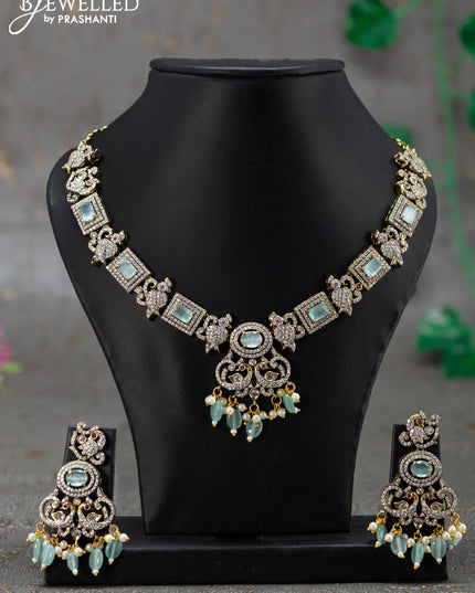 Necklace with mint green & cz stones and beads hanging in victorian finish