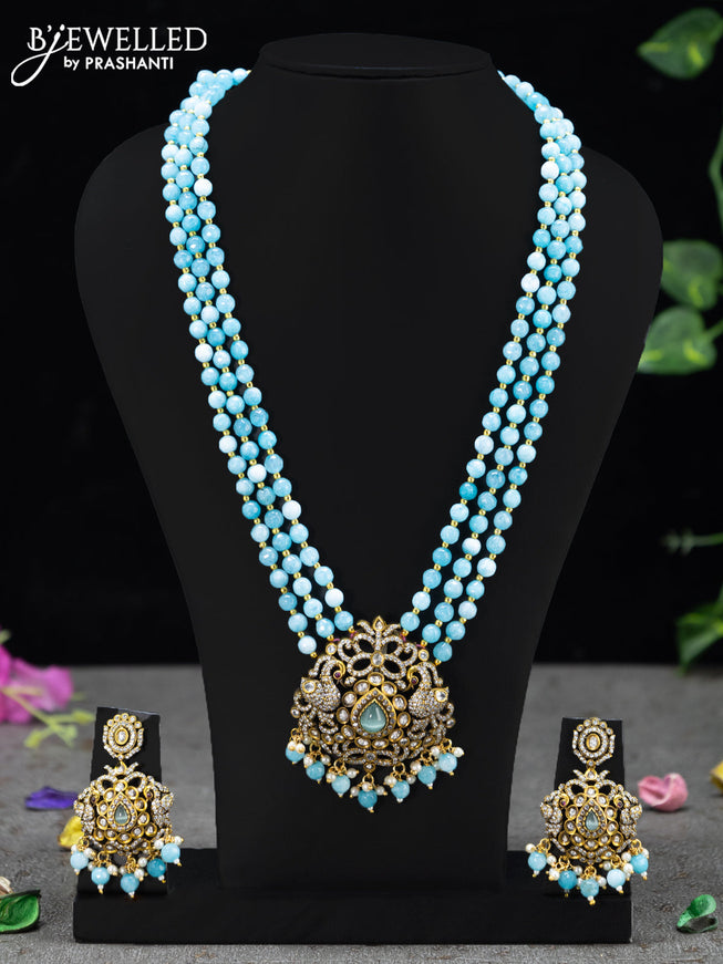Beaded triple layer ice blue necklace peacock design with cz stones and beades hanging in victorian finish