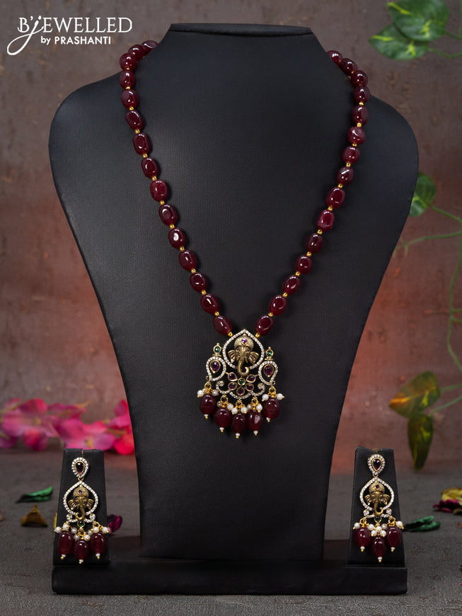 Beaded maroon necklace ganasha design with kemp & cz stones and beads hanging in victorian finish