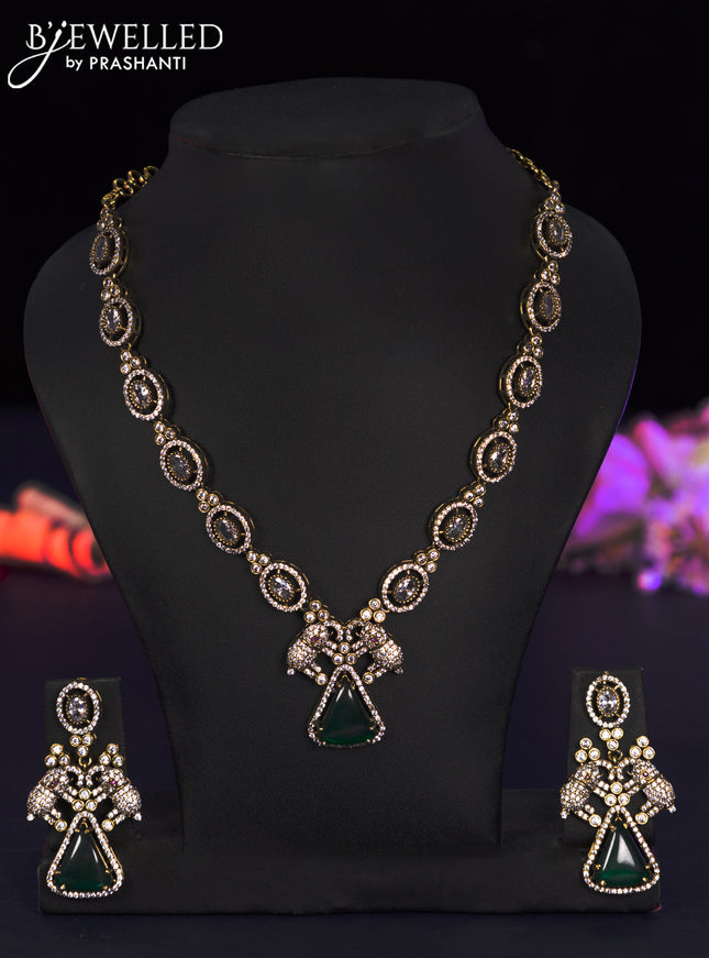 Necklace elephant design with emerald and cz stones in victorian finish