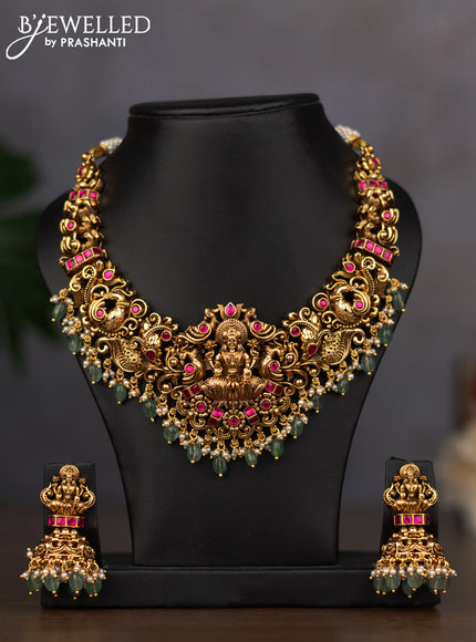 Antique necklace lakshmi design with pink jadau stones and green beads hanging