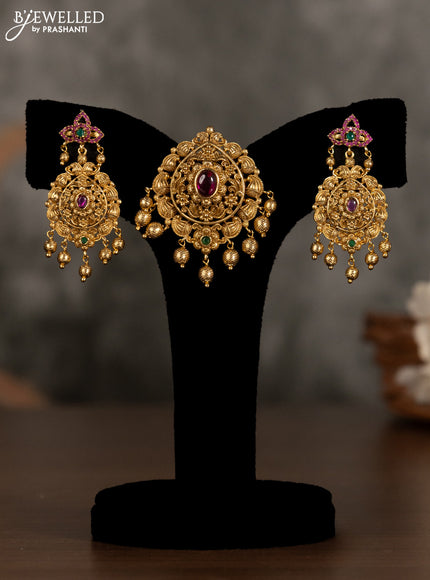 Antique pendant set with kemp stones and golden beads hanging