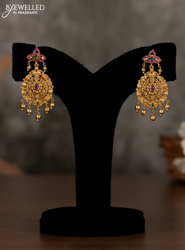 Antique pendant set with kemp stones and golden beads hanging