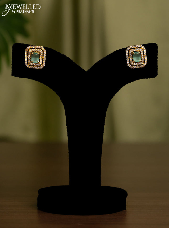 Zircon earrings with mint green and cz stones in gold finish