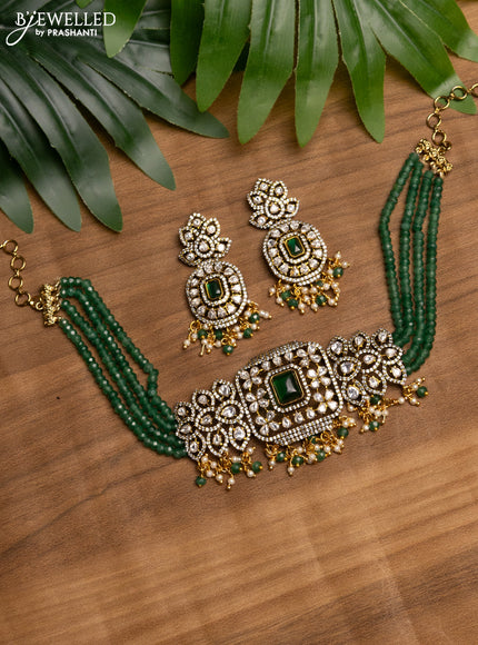 Beaded green choker with emerald & kundan stones and beads hanging in victorian finish