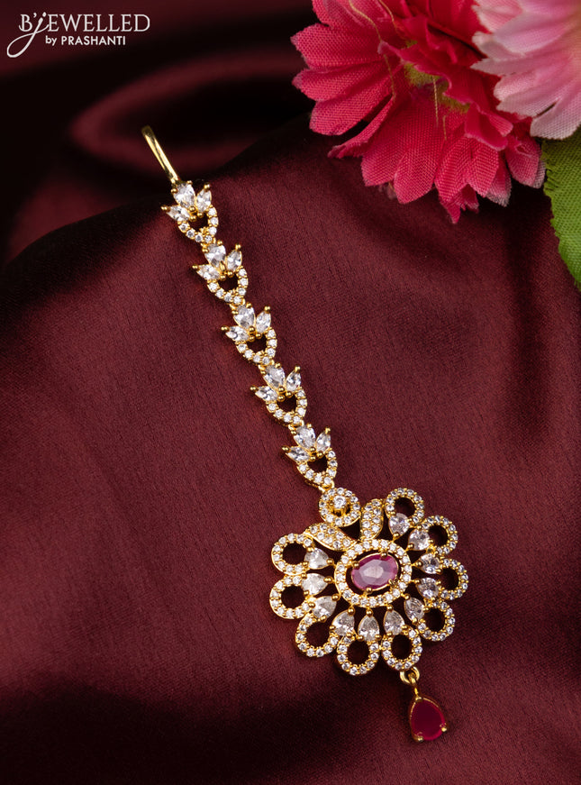 Zircon maang tikka with ruby & cz stones and hangings in gold finish