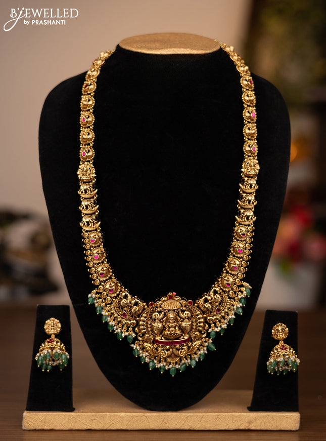 Antique haaram lakshmi design with pink jadau stones and green beads hanging