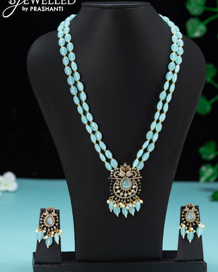 Beaded double layer ice blue necklace with peacock design cz stones and beades hanging in victorian finish