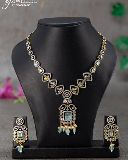 Necklace with mint green & cz stones and beads hanging in victorian finish