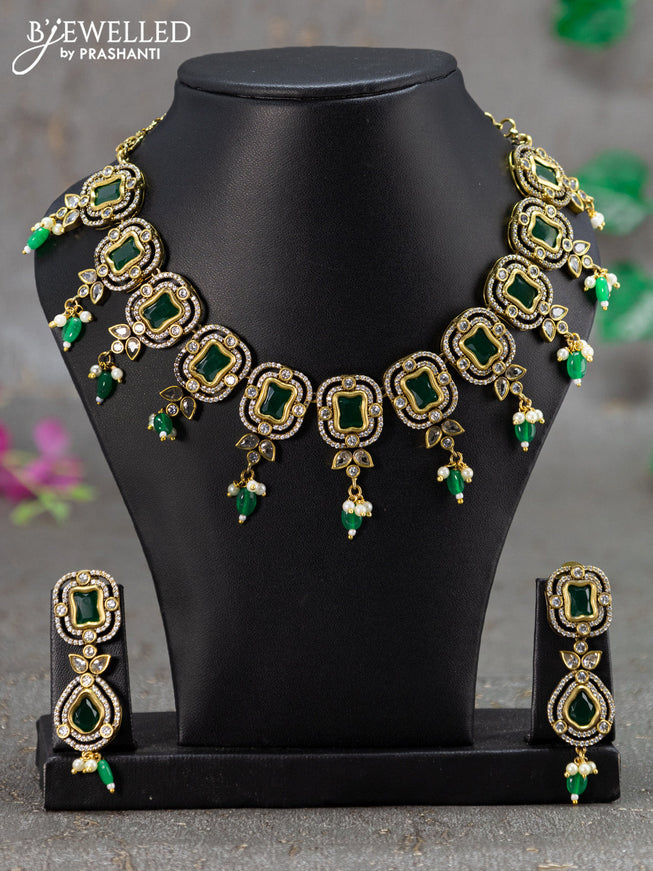 Necklace with emerald & cz stones and green beads hanging in victorian finish