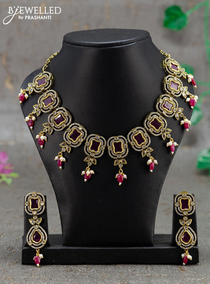 Necklace with pink kemp & cz stones and beads hanging in victorian finish