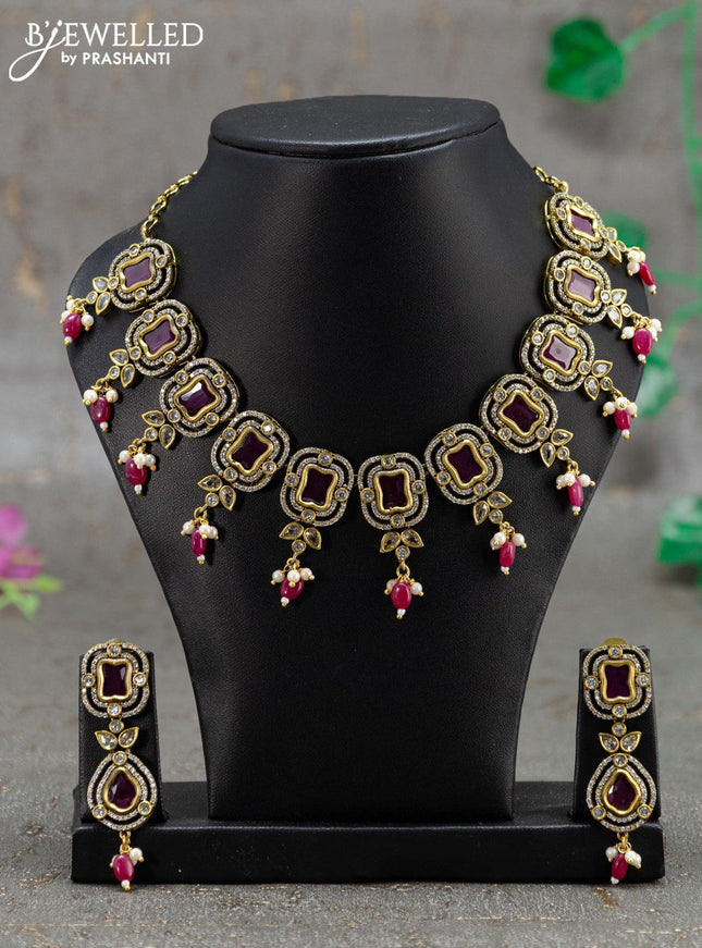 Necklace with pink kemp & cz stones and beads hanging in victorian finish