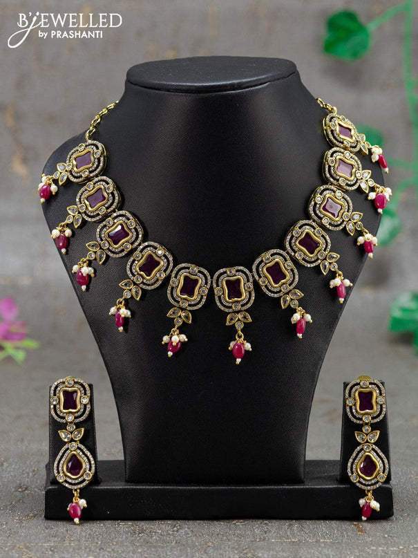 Necklace with pink kemp & cz stones and beads hanging in victorian finish