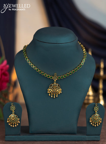 Attigai necklace with emerald stones and golden beads hangings in gold finish