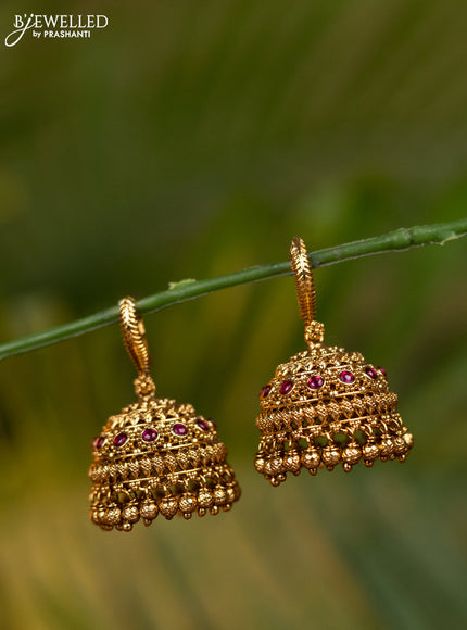 Antique hanging type jhumka with pink kemp stones and golden beads hangings