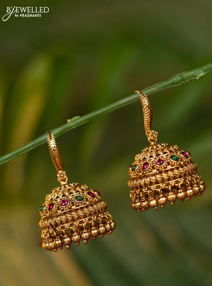 Antique hanging type jhumka with kemp stones and golden beads hangings