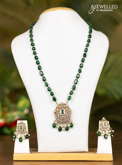 Beaded dark green necklace with double peacock pendant in victorian finish