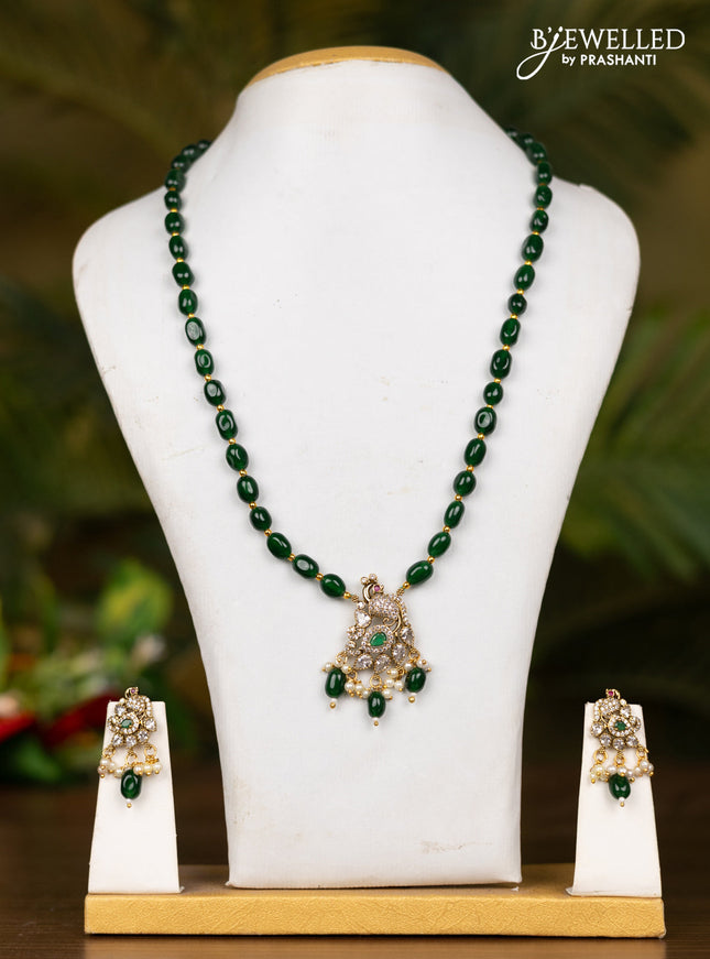 Beaded dark green necklace with peacock pendant in victorian finish