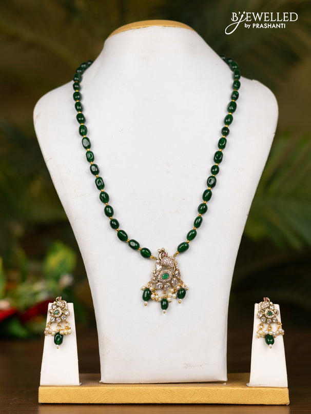 Beaded dark green necklace with peacock pendant in victorian finish