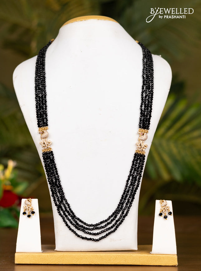 Beaded black necklace with antique peacock pendant in kemp and white stones