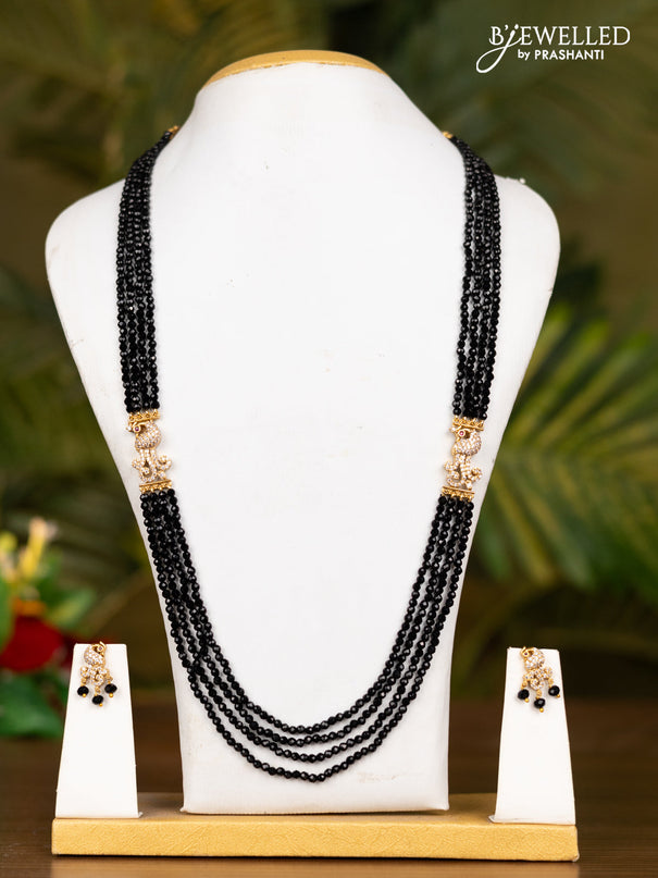 Beaded black necklace with antique peacock pendant in kemp and white stones