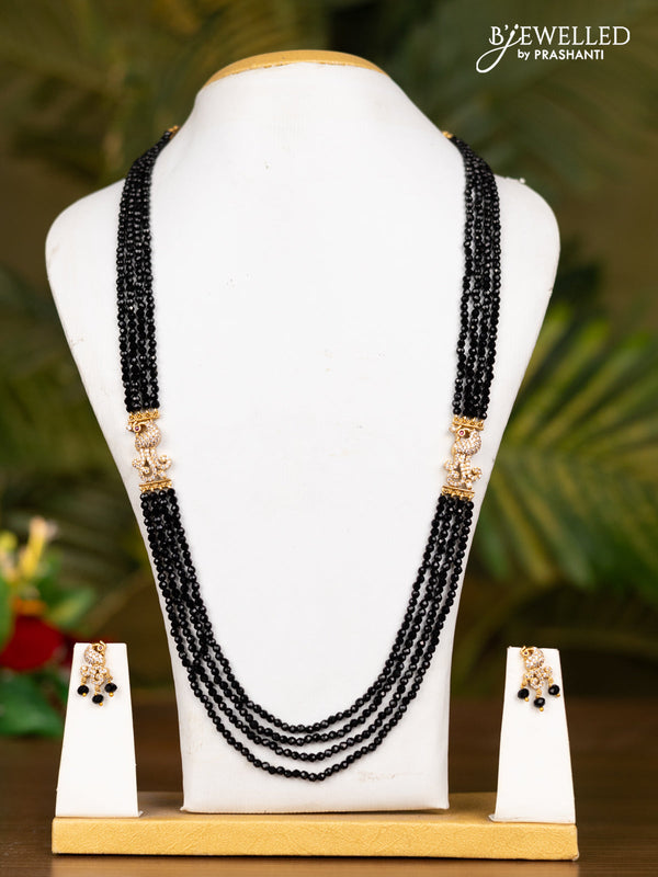 Beaded black necklace with antique peacock pendant in kemp and white stones