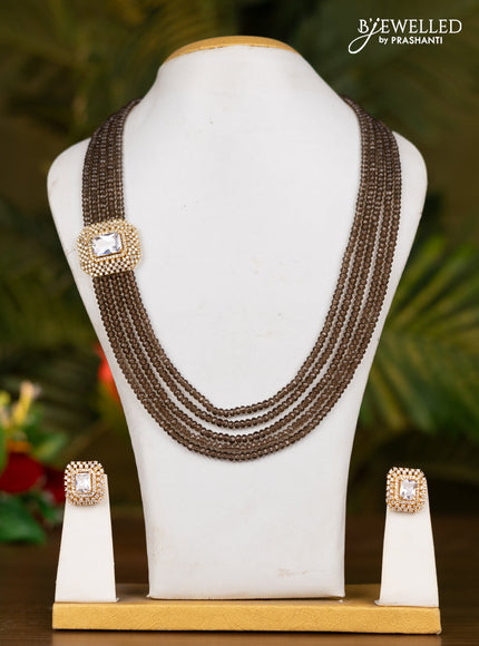 Beaded brown necklace with white stone pendant