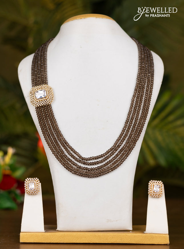 Beaded brown necklace with white stone pendant