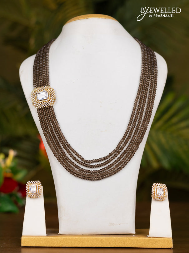 Beaded brown necklace with white stone pendant